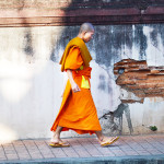 24 Photos That Will Inspire You to Travel the World NOW -- A monk takes to Chiang Mai's streets #photograph #travel #wanderlust | CameraAndCarryOn.com